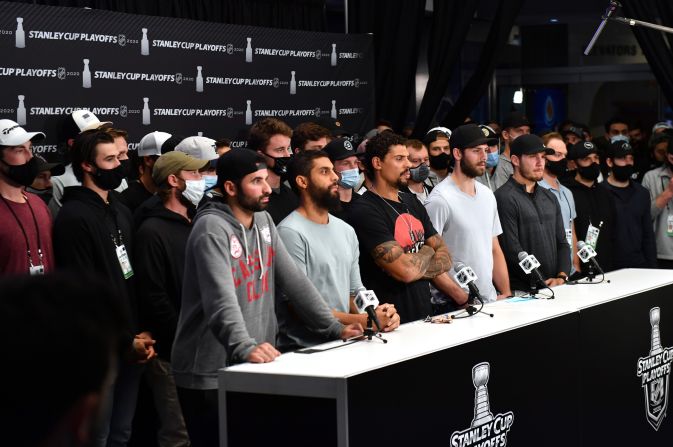 Members of the NHL's Colorado Avalanche, Vegas Golden Knights, Dallas Stars and Vancouver Canucks gather together after their playoff games were postponed in Edmonton, Alberta.