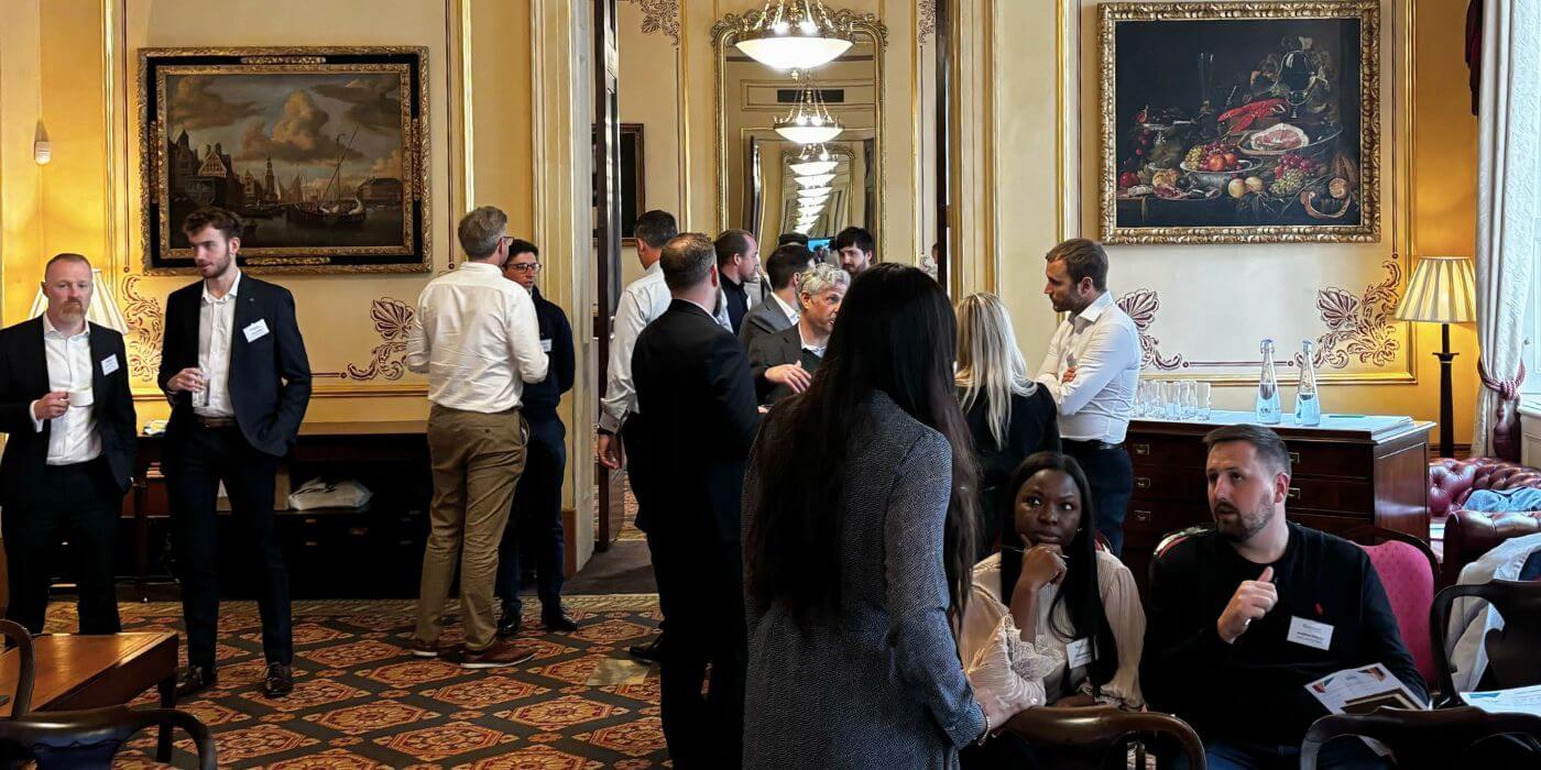 Attendees at ascend london 2024 engaging in discussions during a networking session about the future of grc.