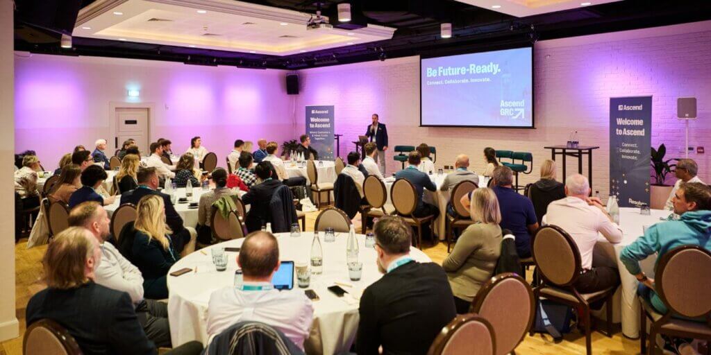 Resolver's customer success manager chris morriss speaks to a crowded room of customers at ascend grc london 2025