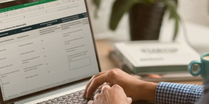 Male hands typing on laptop representing security audit