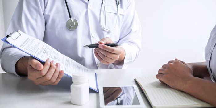 Doctor sharing results on notepad representing workplace violence in hospitals