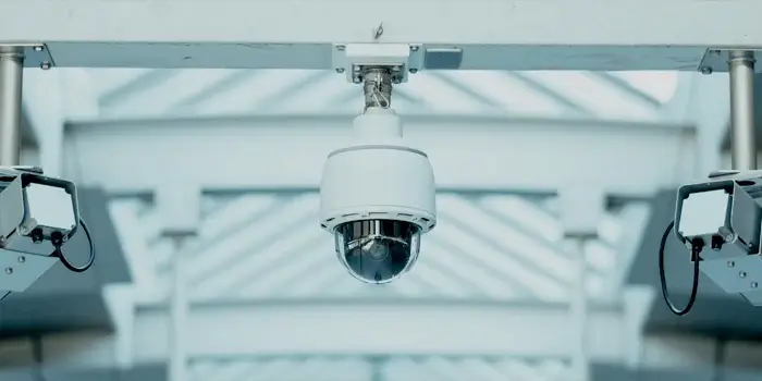 Security camera in a modern corporate setting, representing 3 critical projects for enhancing business continuity for corporate security teams